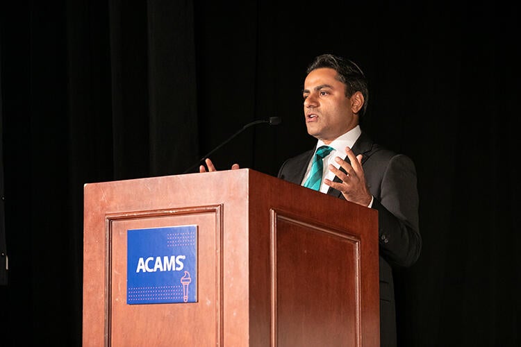 Rohit Sharma opening remarks on podium at the ACAMS NYC 2019 Conference