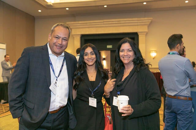 LATAM Conference Recap Photo - Three attendees in the networking hall