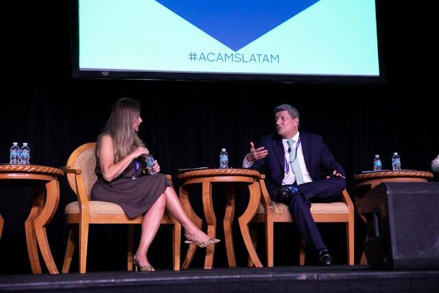 LATAM Conference Recap Photo - Two panel members discussing a topic