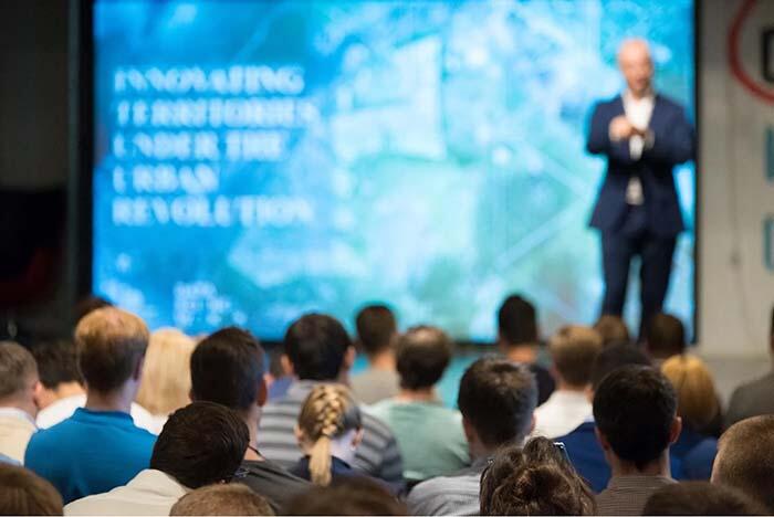 Audience listens to a speaker at a conference