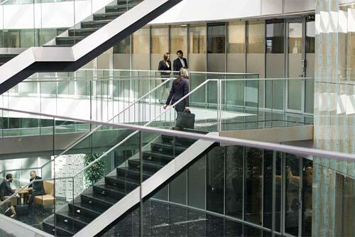 Businesswoman walking up steps in building