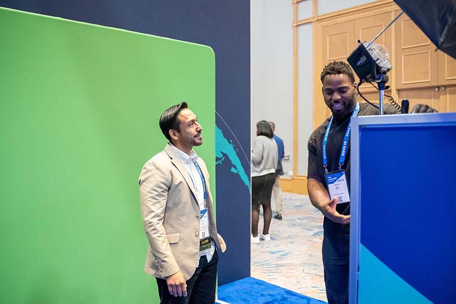 ACAMS Hollywood attendee posing in front of a green screen