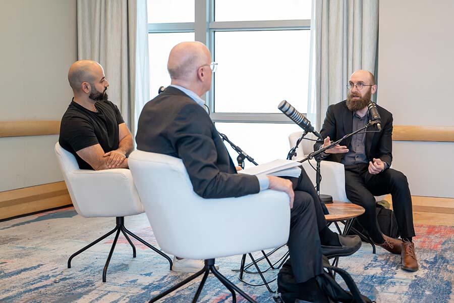 Three experts conducting a live podcast