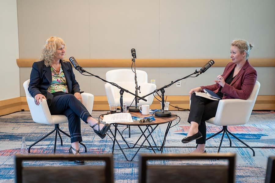 Two experts engaging in a live podcast