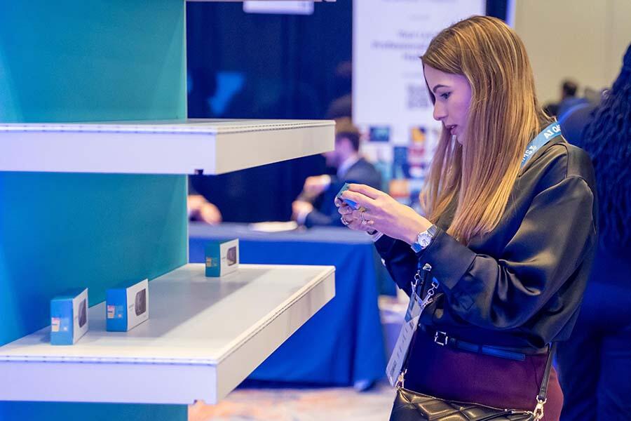 ACAMS Hollywood attendee looking at a product on a shelf
