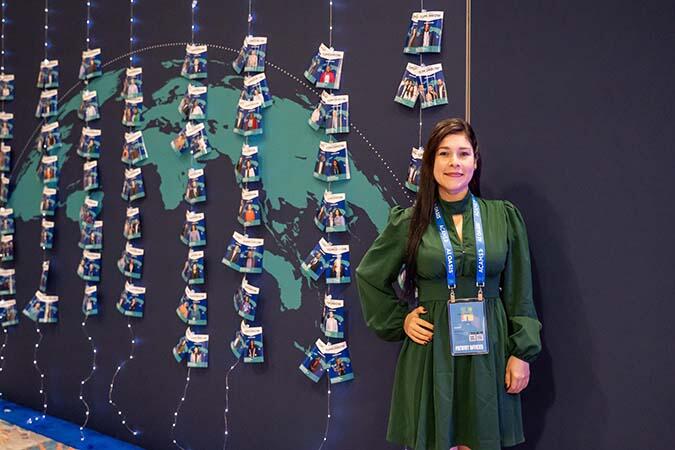 ACAMS Hollywood attendee posing in front of globe