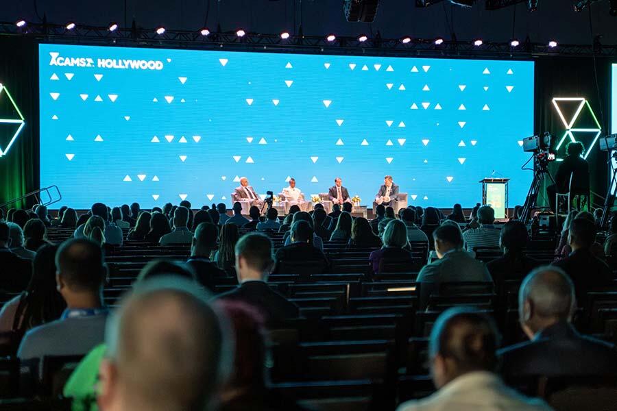 Audience view of four experts engaging in a panel discussion