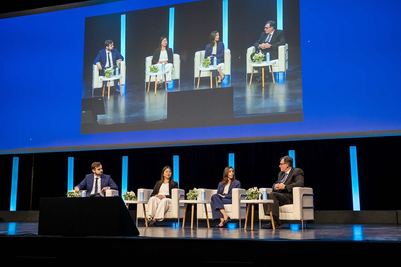 Four expert speakers talking in the ACAMS Europe Assembly auditorium