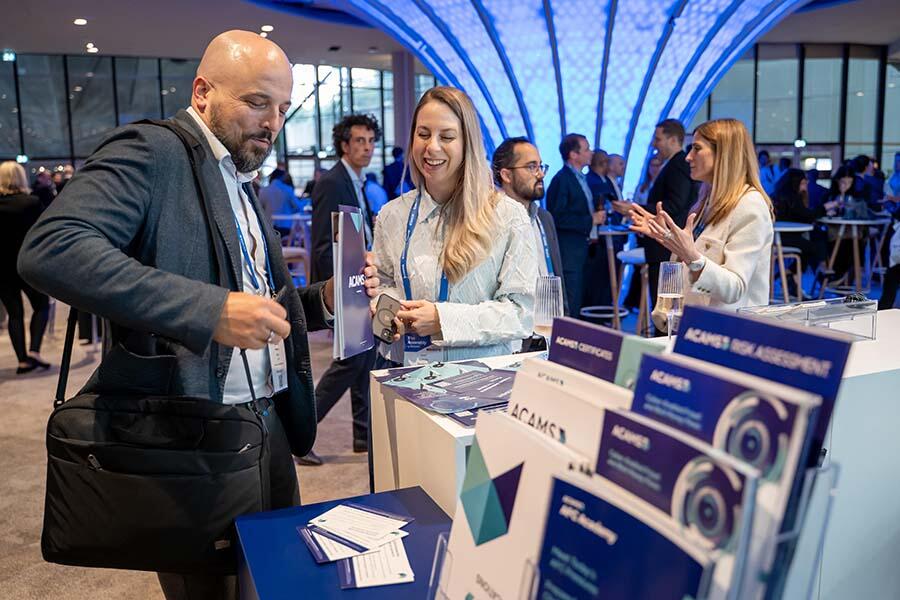 Attendees checking out the ACAMS booth at the Assembly Europe
